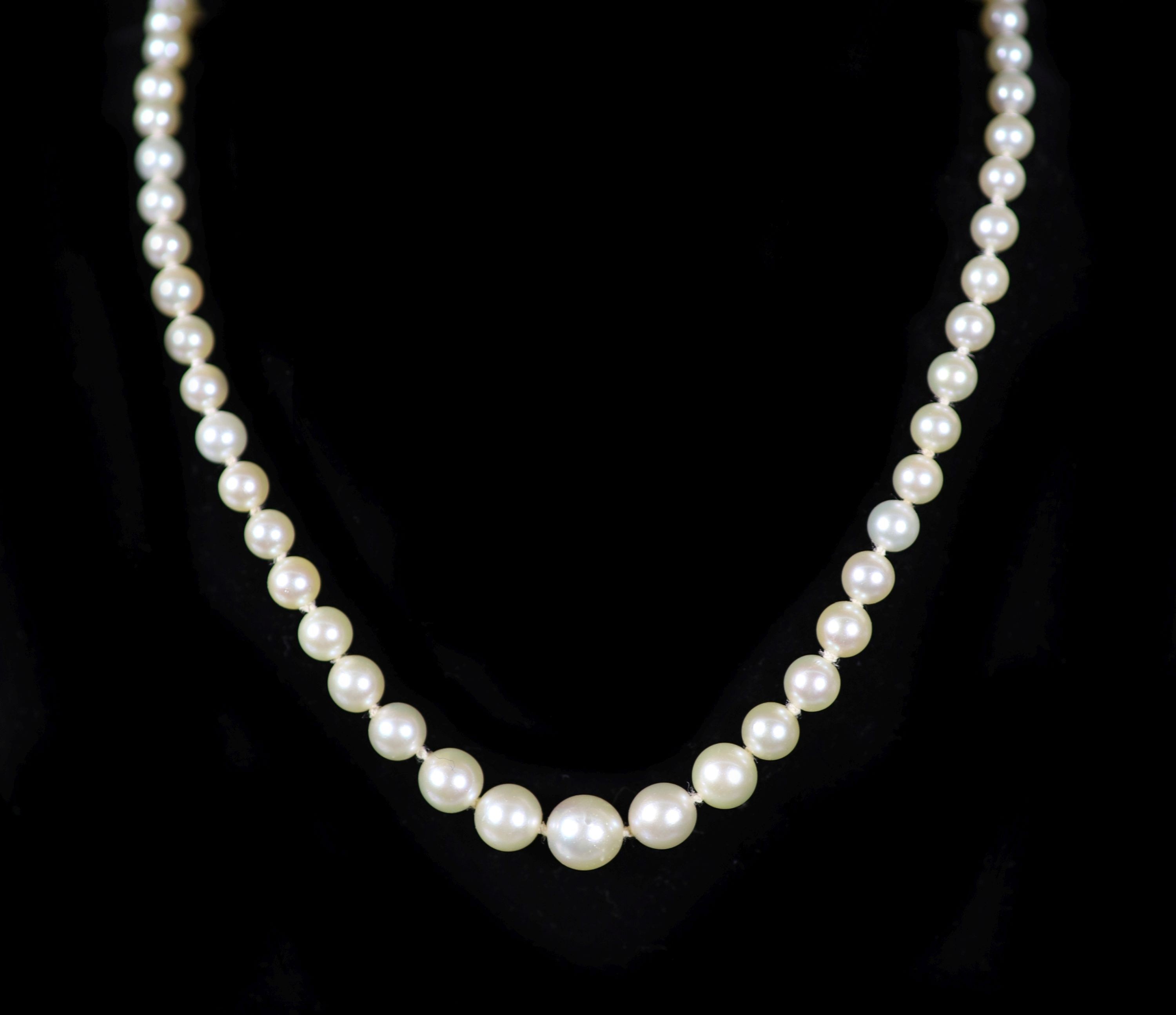 A mid 20th century single strand graduated pearl necklace, with platinum and diamond set open work