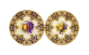 A pair of Royal Worcester fruit painted dessert plates, signed A. Shuck, c.1918,each within gilt-