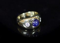 A Cartier 18ct gold , gypsy set cabochon sapphire and two stone diamond ring,signed Cartier, size M,