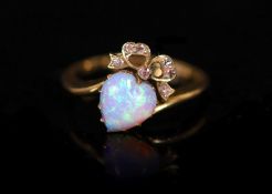 A late Victorian gold, heart shaped opal and diamond set crossover ring,with ribbon bow motif,