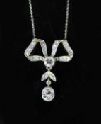 An early 20th century gold, platinum and diamond set drop ribbon bow pendant necklace,on a fine link