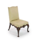 A George II red walnut side chairwith upholstered back and seat, with ornately carved scrolling