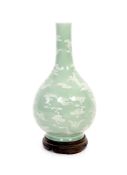 A Chinese celadon-glazed slip-decorated bottle vase, Qianlong seal mark and period (1736-95),