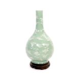 A Chinese celadon-glazed slip-decorated bottle vase, Qianlong seal mark and period (1736-95),