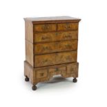 A George II walnut chest on standwith moulded cornice, two short and three graduated long drawers