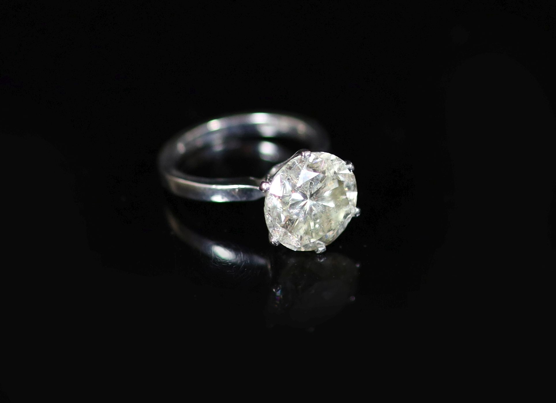 A modern 18ct white gold and solitaire diamond ring,the stone measuring 10.7mm in diameter, (no