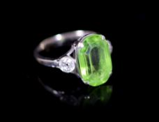 A 9ct white gold oval cut peridot set dress ring, with diamond set shoulders,size M, gross weight