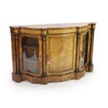 A Victorian marquetry inlaid figured walnut side cabinetof serpentine form with central panelled