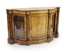 A Victorian marquetry inlaid figured walnut side cabinetof serpentine form with central panelled