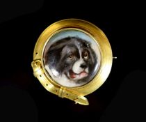 A Victorian gold and enamel circular brooch, decorated with the head of a dog, inscribed verso 'W.
