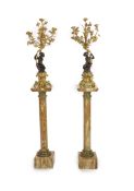 A pair of 19th century French bronze and ormolu six light candelabra,modelled as putti supporting