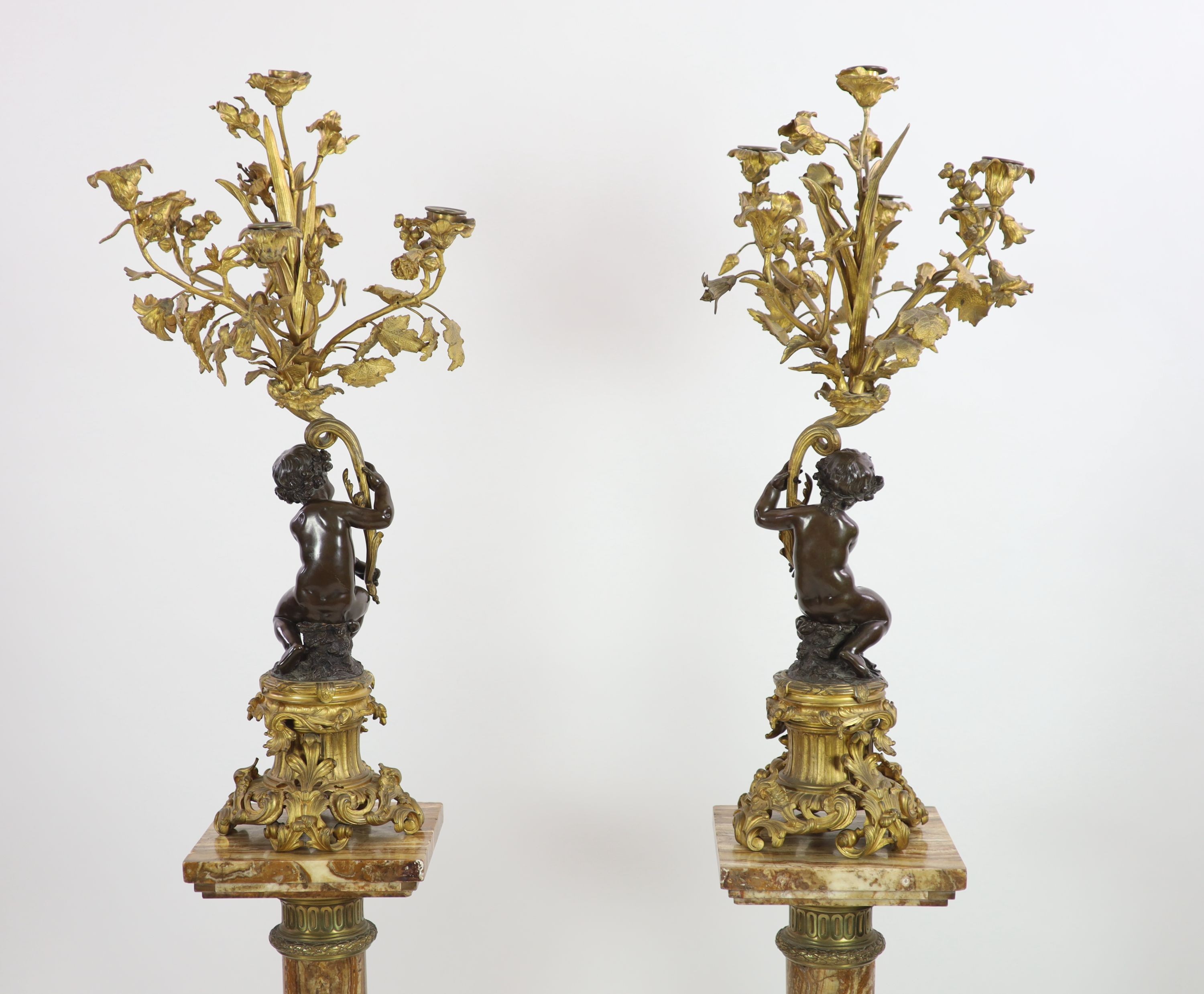 A pair of 19th century French bronze and ormolu six light candelabra,modelled as putti supporting - Image 6 of 6