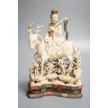 A Chinese carved ivory figure of a female immortal riding a deer, early 20th century, height 17cm