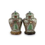 A pair of Chinese enamelled porcelain jars and covers, in Transitional style,34cm high, wood stands