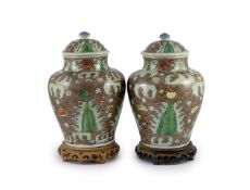 A pair of Chinese enamelled porcelain jars and covers, in Transitional style,34cm high, wood stands