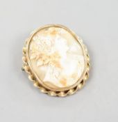 A late Victorian yellow metal mounted oval cameo shell brooch, carved with the bust of a lady to