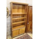 A mid century walnut open bookcase, width 102cm, depth 31cm, height 220cm