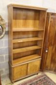 A mid century walnut open bookcase, width 102cm, depth 31cm, height 220cm