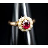 A yellow metal, ruby and seed pearl circular cluster ring, size N, gross weight 3.2 grams.