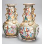 A pair of late 19th century Chinese famille rose vases, decorated with figures, birds and