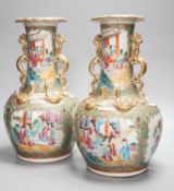 A pair of late 19th century Chinese famille rose vases, decorated with figures, birds and