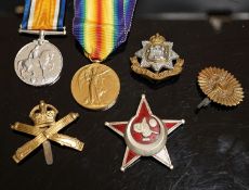 A WWI pair to 23125 PTE. H. ROFE E.SUR. R., together with an East Surrey Regiment cap badge, two