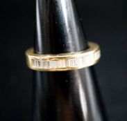 A continental 750 yellow metal and baguette cut diamond set half eternity ring, size L, gross 5.1