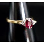 A 750 yellow metal, single stone oval cut ruby and six stone diamond chip set ring, size O, gross