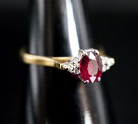 A 750 yellow metal, single stone oval cut ruby and six stone diamond chip set ring, size O, gross