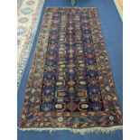 An antique Caucasian blue ground rug, 260 x 130cm