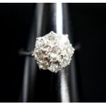 A white metal and diamond cluster ring, size J, gross 2 grams.