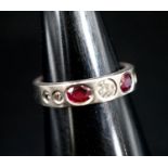A white metal and gypsy set ruby and diamond set half hoop ring, size M, gross 6.1 grams.