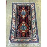 A Caucasian blue ground rug, 126 x 77cm