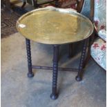 An engraved brass Benares table, diameter 62cm, height 65cm