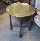 An engraved brass Benares table, diameter 62cm, height 65cm