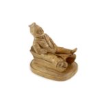 A North European novelty carved beech inkwell in the form of a seated figure sledging, c.1900,