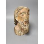 A 16th/17th century carved and polychrome painted pine head of a saint, 26cm