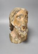 A 16th/17th century carved and polychrome painted pine head of a saint, 26cm