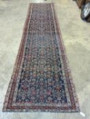 An antique Shirvan blue ground runner, 470 x 116cm