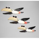 A graduated trio of Guinness toucans, widest 25cm