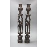 A pair of African tribal figural ebony candlestands, 60cm
