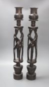 A pair of African tribal figural ebony candlestands, 60cm