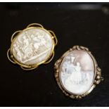 An Edwardian yellow metal mounted carved oval cameo shell and a gilt metal mounted cameo shell