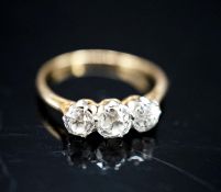 A yellow metal and three stone diamond ring, size M, gross 1.9 grams.