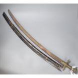 An Indonesian sword with brass handle, 19th century, blade stamped WARE Wd. CAST, in its ebony