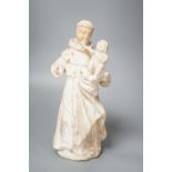 A 19th century carved alabaster group, friar with child 28cm