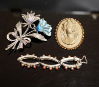 A 19th-century Lava cameo brooch, 49mm, a marcasite and enamel floral spray brooch and a coral