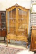 A George I style figured walnut display cabinet with glazed doors on cabriole supports and