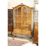 A George I style figured walnut display cabinet with glazed doors on cabriole supports and