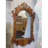 A George III style walnut fret cut and carved giltwood wall mirror, width 49cm, height 86cm